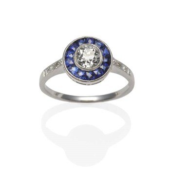 Lot 272 - An Art Deco Style Diamond and Sapphire Ring, an old cut diamond within a border of calibré cut...
