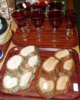 Lot 165 - A set of six cranberry wine glasses with gilt decoration, a pair of similar smaller glasses and two