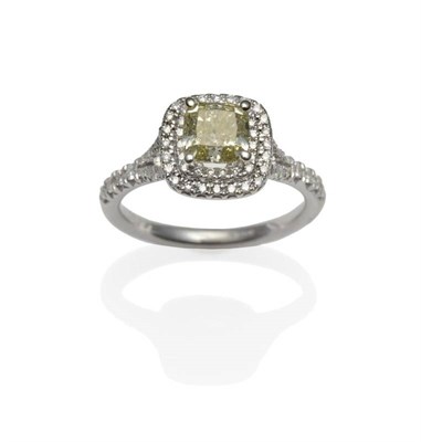 Lot 273 - An 18 Carat White Gold Diamond Cluster Ring, with a fancy greenish yellow cushion cut diamond...