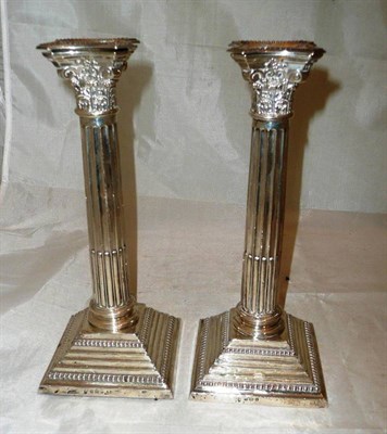 Lot 186 - A pair of George V silver Corinthian column candlesticks, Birmingham 1910, loaded