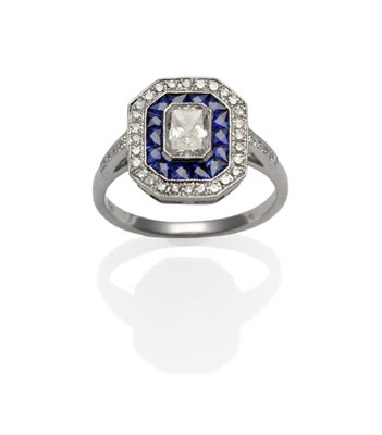Lot 277 - An Art Deco Style Diamond and Sapphire Ring, a radiant cut diamond within a border of calibré...