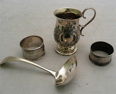 Lot 219 - A silver Christening mug and a sauce ladle and two napkin rings