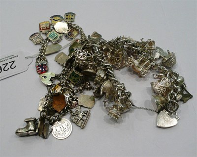 Lot 226 - Three charm bracelets hung with various charms and souvenirs