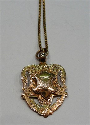 Lot 243 - A 9ct gold shield on a box chain