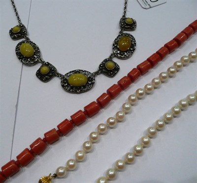 Lot 260 - A cultured pearl necklace with clasp, a coral necklace and a stone-set necklace