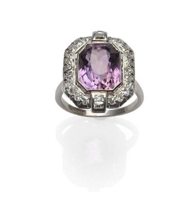 Lot 282 - An Amethyst and Diamond Cluster Ring, an octagonal brilliant cut amethyst within a border of...