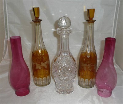 Lot 297 - A pair of early 19th century amber coloured decanters, two cranberry glass oil lamp chimneys and an