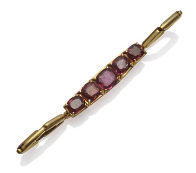 Lot 291 - A Garnet Bracelet, set with five oval cushion cut stones in yellow claw settings, on an...