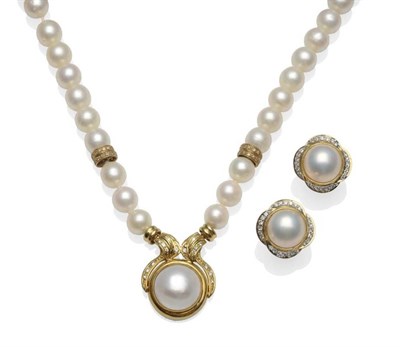 Lot 299 - A Cultured Pearl Necklace with Mabe Pearl and Diamond Centrepiece, the uniform cultured pearls with