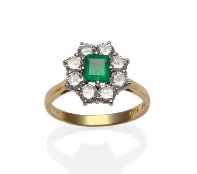 Lot 300 - An 18 Carat Gold Emerald and Diamond Cluster Ring, the step cut emerald within a border of...