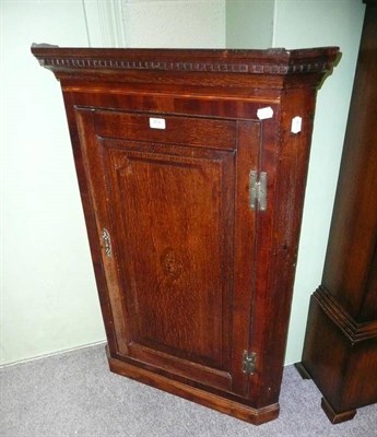 Lot 458 - An oak corner cupboard