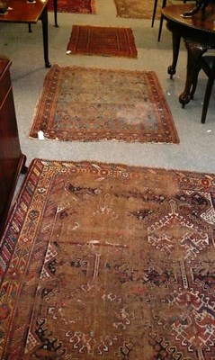 Lot 459 - A Kashgai rug (worn) measures 194cm x 144cm. together with an Afshar rug and a Balouch rug (3)