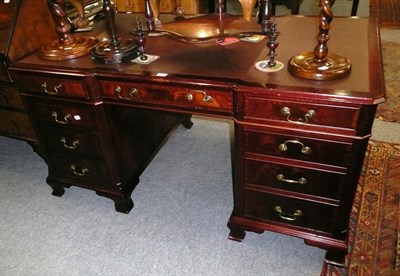 Lot 460 - A reproduction mahogany pedestal desk, the top with three frieze drawers, three cupboards to...