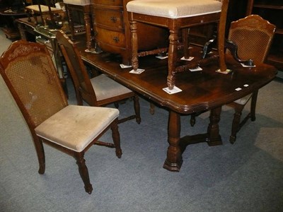 Lot 464 - An oak dining table with parquetry top, two leaves and six chairs