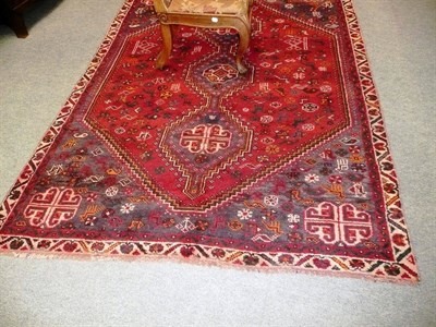 Lot 492 - Shiraz rug south west Persia, the raspberry lozenge field of animals birds and flower heads...