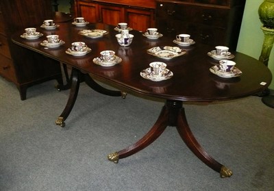 Lot 498 - Regency-style twin pillar mahogany dining table