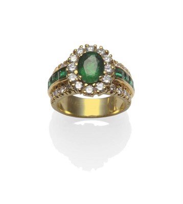 Lot 305 - An Emerald and Diamond Cluster Ring, the oval mixed cut emerald within a border of round...