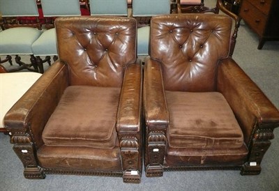 Lot 514 - A pair of carved oak and leather upholstered easy chairs