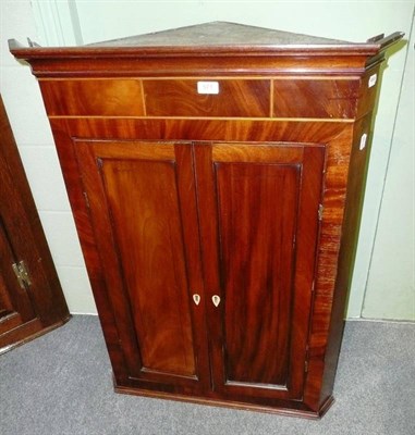 Lot 571 - A mahogany corner cupboard