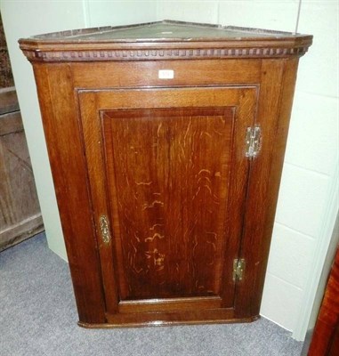 Lot 572 - George III oak hanging corner cupboard