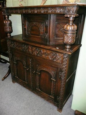 Lot 577 - A carved oak court cupboard