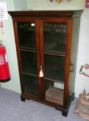 Lot 599 - A glazed oak bookcase