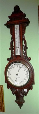 Lot 611 - An oak aneroid barometer retailed by Fattorini and Sons, Bradford