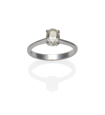 Lot 316 - An 18 Carat White Gold Diamond Solitaire Ring, the oval cut diamond in a four claw setting to a...