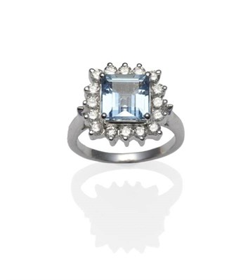 Lot 317 - An Aquamarine and Diamond Cluster Ring, the square step cut aquamarine within a border of round...