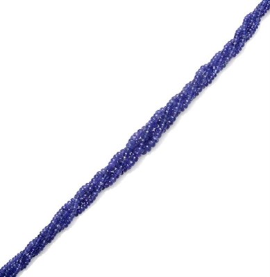 Lot 318 - A Tanzanite Necklace, four rows of graduated faceted tanzanite beads entwined, and strung to a...