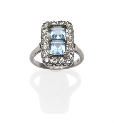 Lot 322 - An Aquamarine and Diamond Cluster Ring, two square step cut aquamarines within a border of...