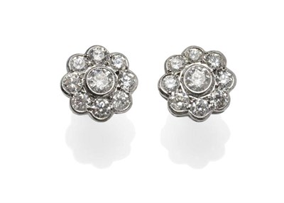 Lot 323 - A Pair of Diamond Cluster Earrings, each comprising nine round brilliant cut diamonds in a circular