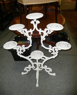 Lot 688 - A white painted cast iron plant stand