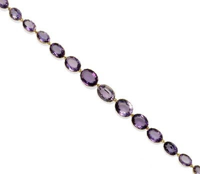 Lot 332 - An Amethyst Necklace, the oval cut stones in yellow claw fronted collet style settings, length...