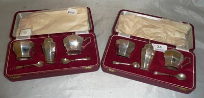 Lot 34 - Two silver three piece condiment sets in fitted cases