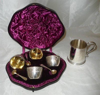 Lot 38 - Four silver salts with gilt interiors and spoons in a fitted case, and a silver Christening mug