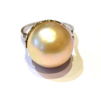 Lot 337 - A Pearl and Diamond Ring, the pearlescent centre stone with graduated eight-cut diamonds in the...