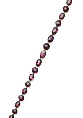 Lot 343 - A 19th Century Garnet Necklace, forty-four oval and round cut garnets in yellow claw fronted collet