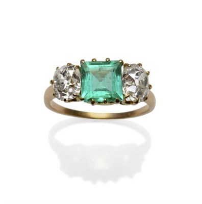 Lot 347 - A Victorian Emerald and Diamond Three Stone Ring, a square step cut emerald between two old cut...