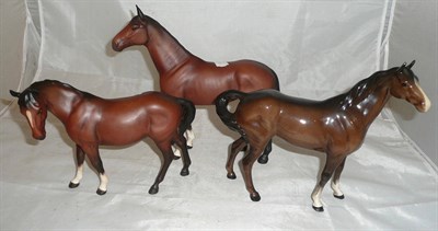 Lot 157 - Two matt Beswick bay horses and another in gloss