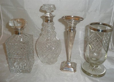 Lot 169 - Two cut glass decanters with silver mounts, silver spill vase and celery vase with silver rim (4)
