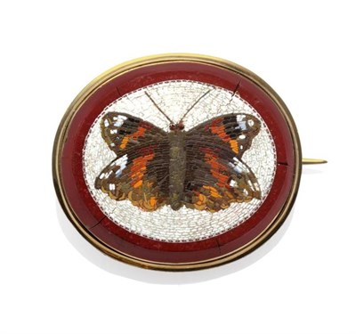 Lot 349 - A Micro-Mosaic Mourning Brooch, depicting a butterfly within an oval cornelian, a locket to the...