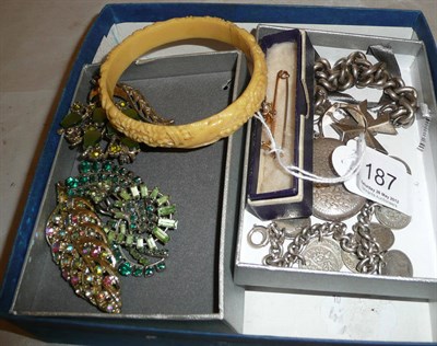 Lot 187 - A bug bar brooch set with demantoid garnet and seed pearls, a coin bracelet, a silver bracelet hung