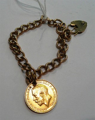 Lot 196 - A rose gold curb and lock bracelet hung with a 1915 sovereign