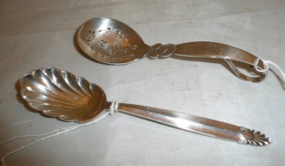 Lot 199 - Georg Jensen sifter spoon inscribed 'Ruth' and a similar spoon (2)