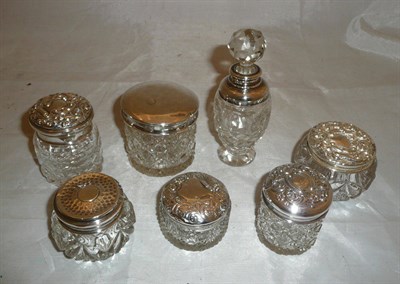 Lot 201 - Six silver topped cut glass dressing table jars and a scent bottle (7)