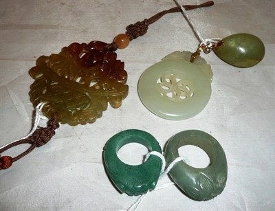 Lot 213 - Two gold mounted jade pendants, two stone rings and a carved pendant with tassel