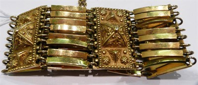 Lot 290 - A fancy link bracelet linked by Etruscan style panels, stamped 750