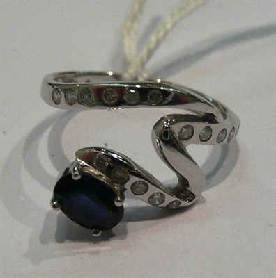 Lot 301 - 18ct white gold diamond and sapphire ring of 'squiggle' form