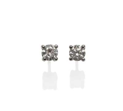 Lot 363 - A Pair of Diamond Solitaire Earrings, the round brilliant cut diamonds in white four claw settings